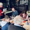 Edith, a member of the board, leads a Sinterklaas bingo game for the clubmembers.